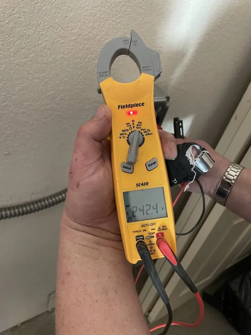 Voltage testing with clamp meter during Recessed Lighting Installation in Forney